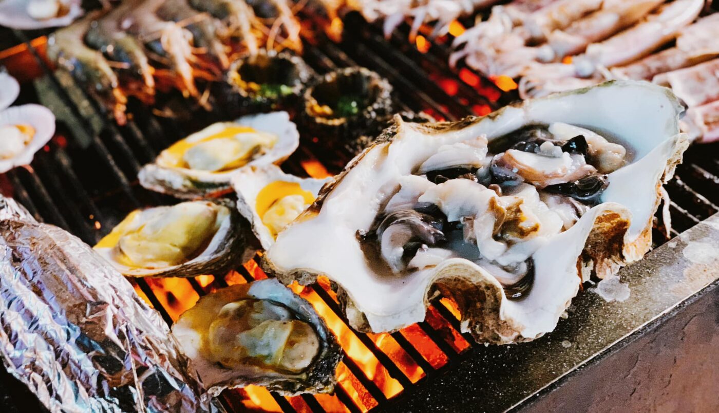 Plates of grilled seafood and lobster served at a beachside restaurant in Con Dao